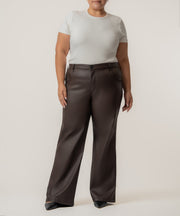 Chocolate coated high-rise straight leg pants paired with a cream short-sleeve t-shirt.