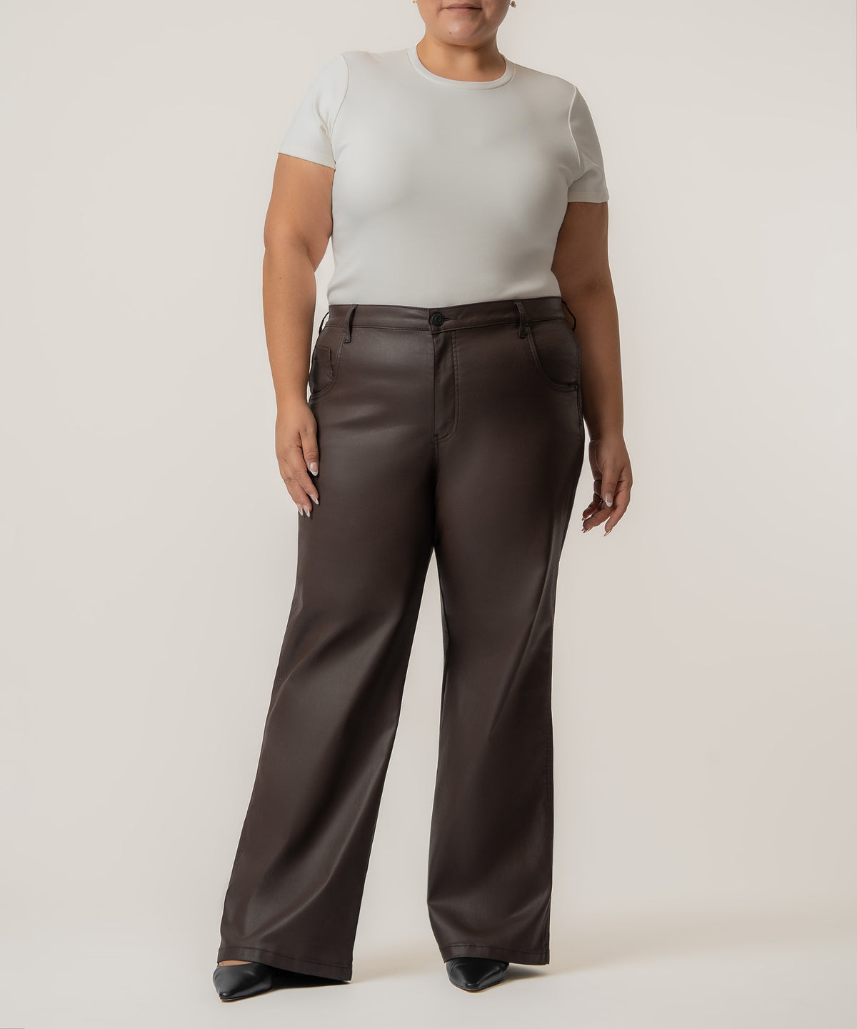 Chocolate coated high-rise straight leg pants paired with a cream short-sleeve t-shirt.