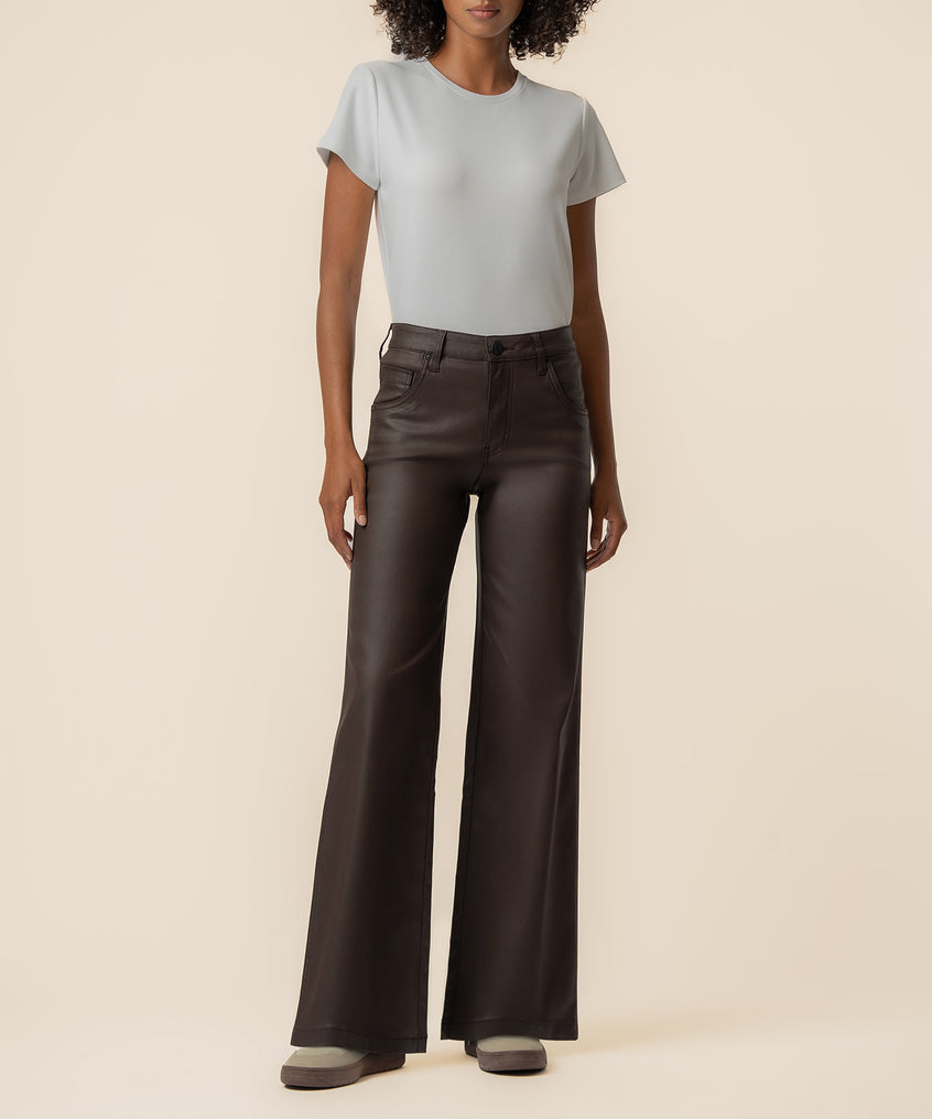 Chocolate brown coated high-rise wide-leg pants with straight silhouette, shown with light gray t-shirt.