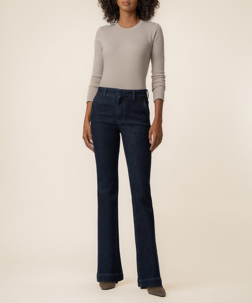 Dark indigo high-rise wide-leg jeans styled with a beige long-sleeve top.