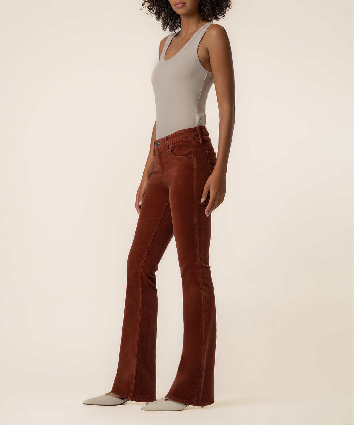 Sienna corduroy bootcut pants with five-pocket styling, shown on model wearing neutral tank top.
