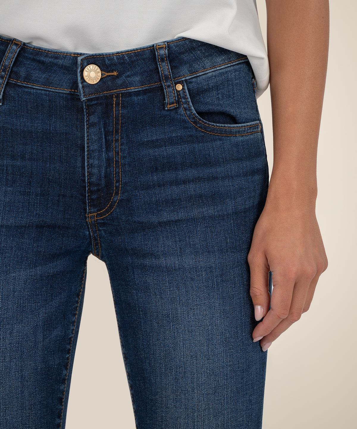 Dark blue mid-rise bootcut jeans with gold button and stitching detail on waistband.