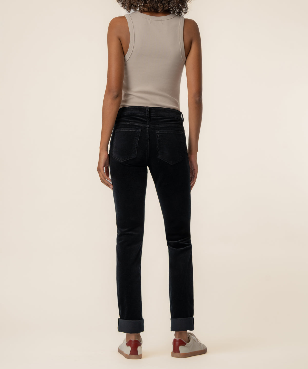 Black corduroy mid-rise boyfriend jeans with rolled cuffs, shown from back view on model wearing gray tank top.