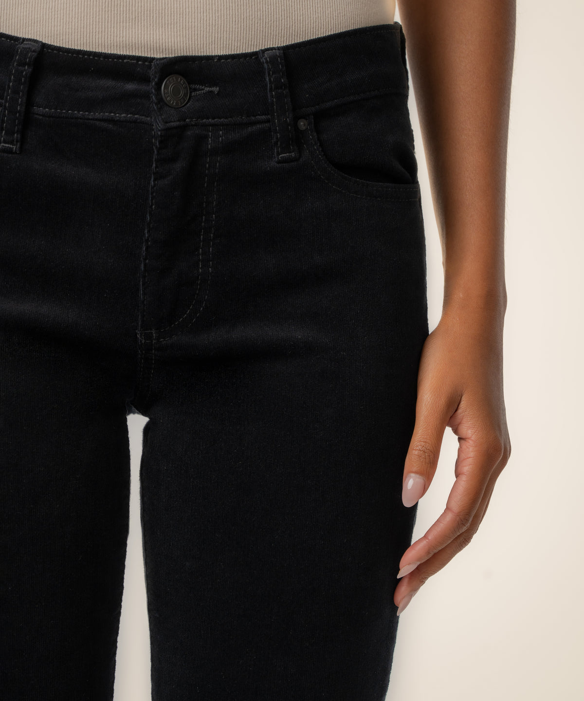 Black corduroy mid-rise boyfriend pants with button closure and visible stitching detail.