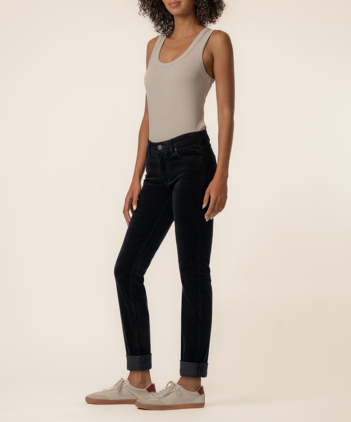 Black corduroy mid-rise boyfriend jeans with rolled cuffs, shown with gray tank top and sneakers.