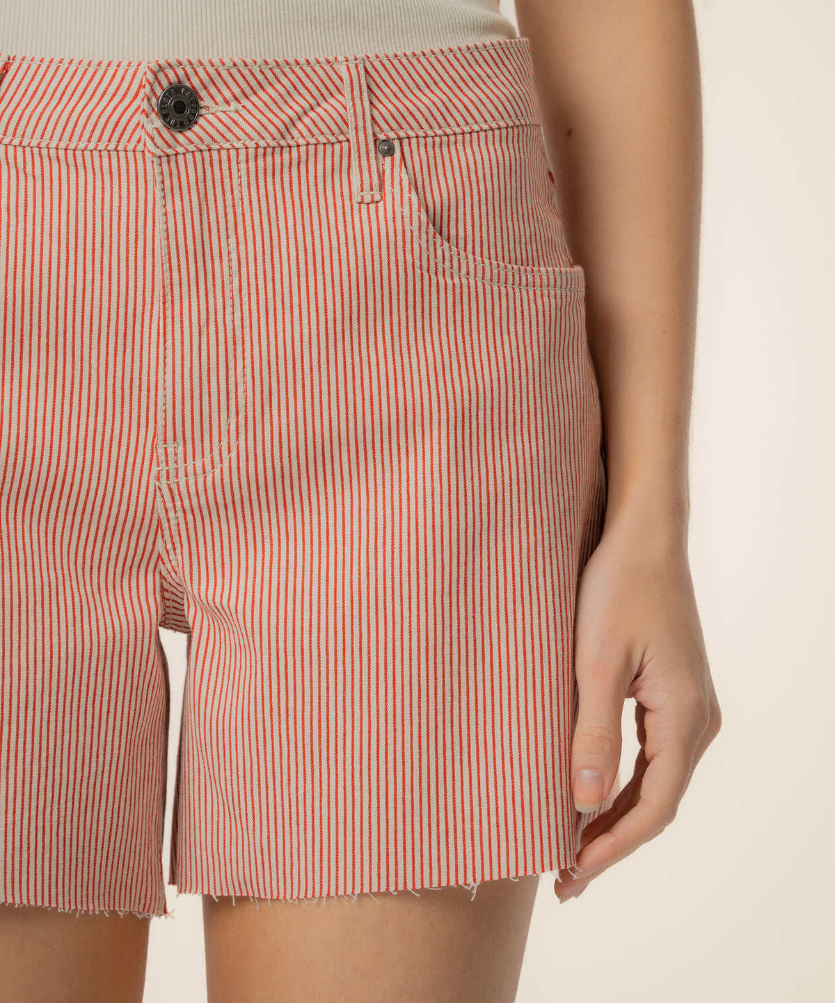 Red and ivory striped twill shorts with high rise waistband and button closure.