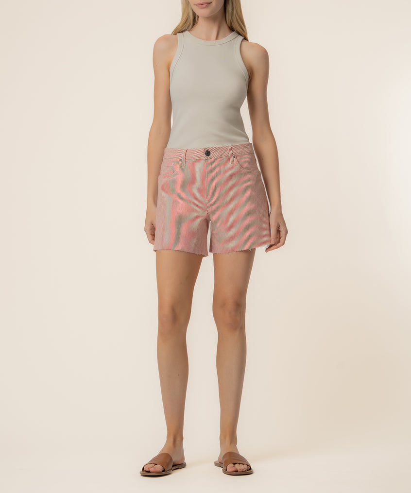Woman wearing cream sleeveless tank top and red and ivory striped high-rise shorts.