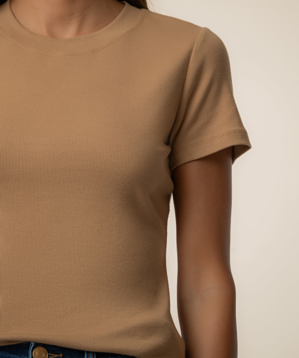 Camel-colored ribbed short-sleeve crew neck top with vertical texture detail.