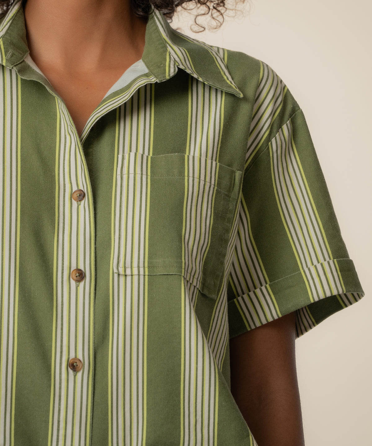 Olive and ivory striped linen button-up top with short sleeves and a chest pocket.