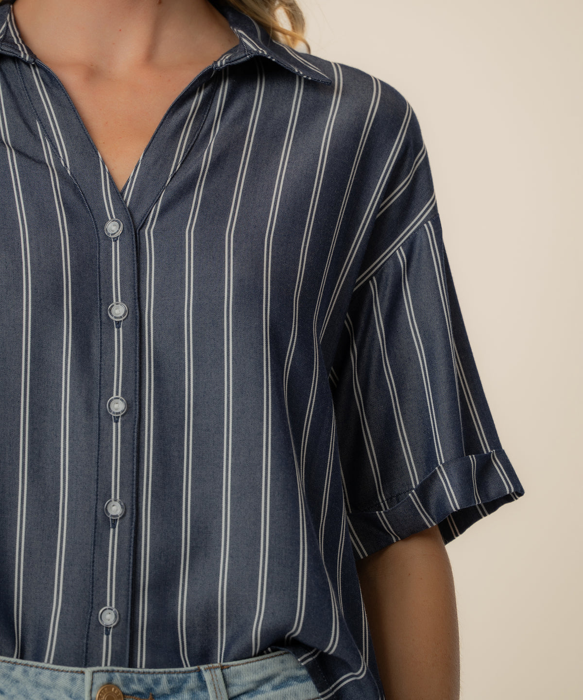 Indigo and white striped boxy button-front shirt with short sleeves and collar.