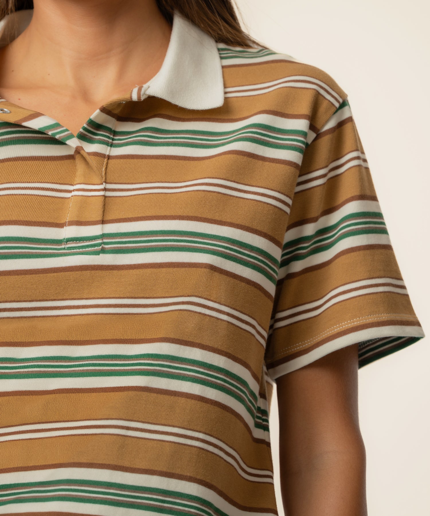 Striped polo shirt with ivory collar featuring brown, green, and white horizontal stripes throughout.